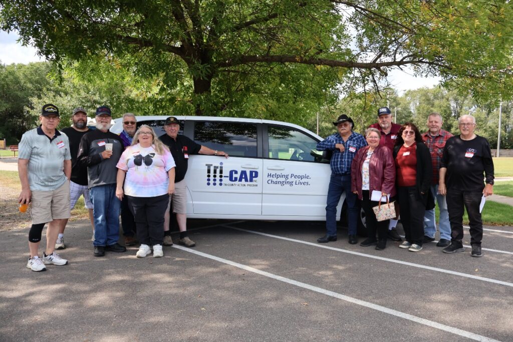 Image of people standing around a white van